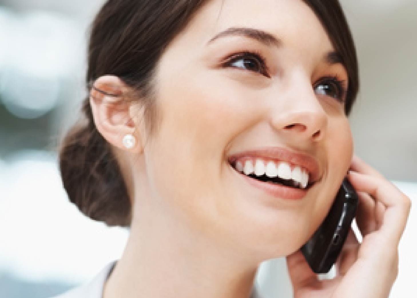 businesswoman happily talking to her friend on the phone